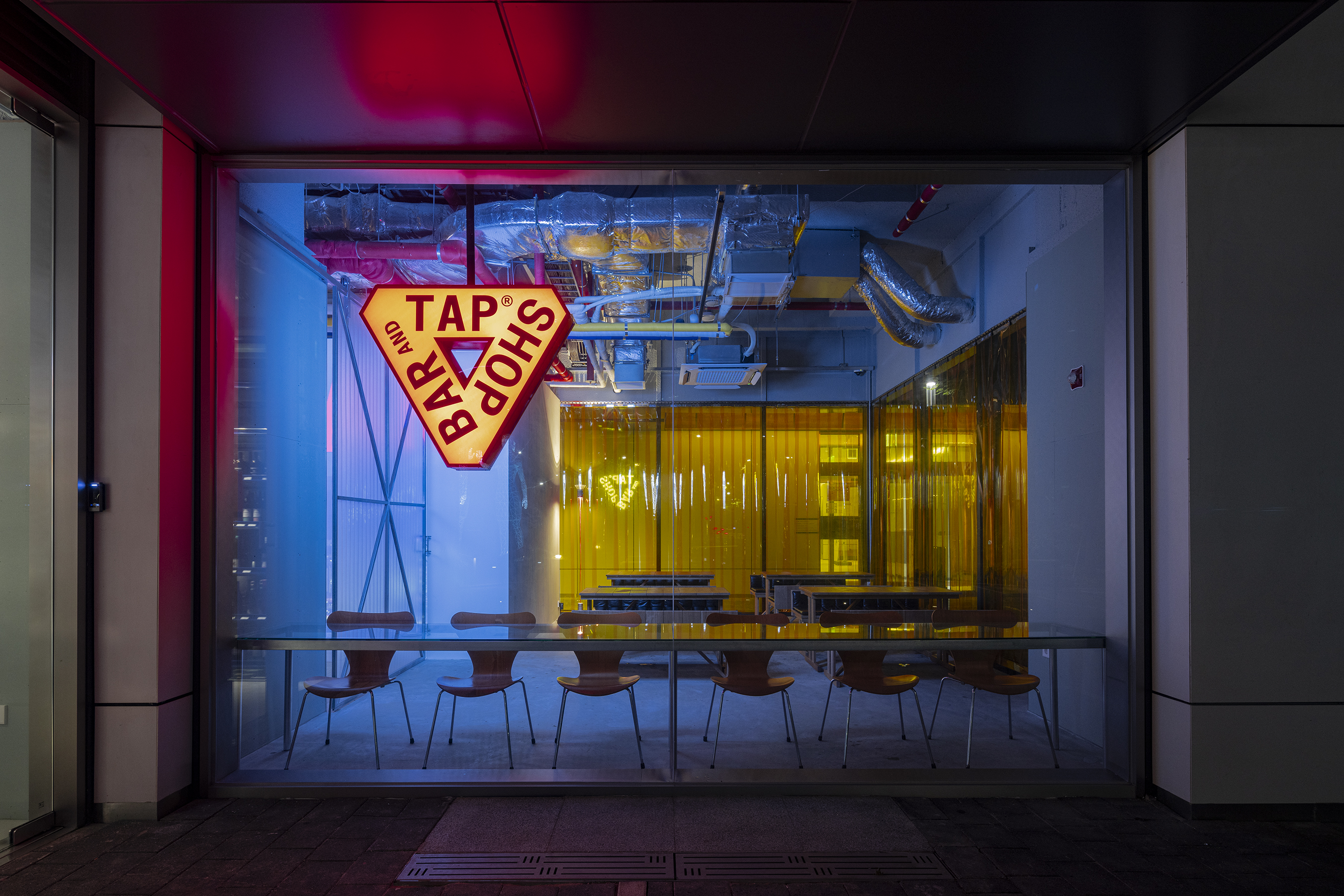 Tap Shop Bar Yeouido with rows of wine taps and bottle wall