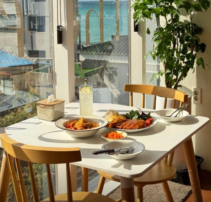 The Flow pasta and ocean-view window over Hyeopjae Beach