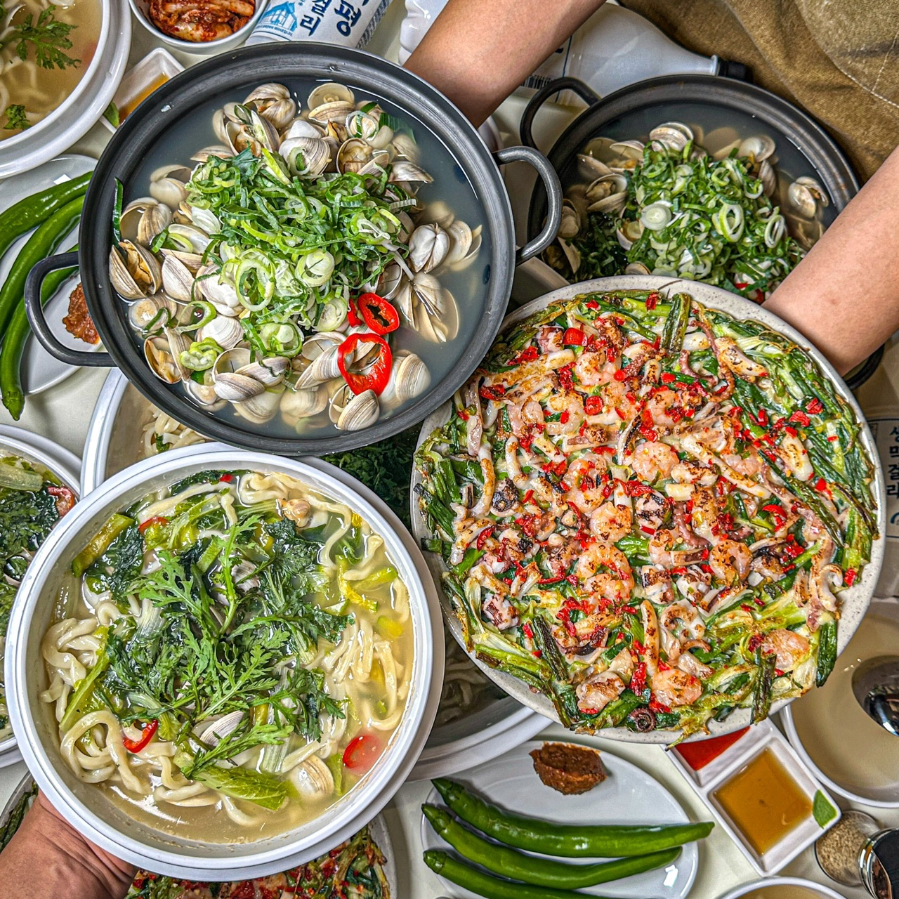 Steamy kalguksu with green chili and fresh toppings at JOJO Kalguksu