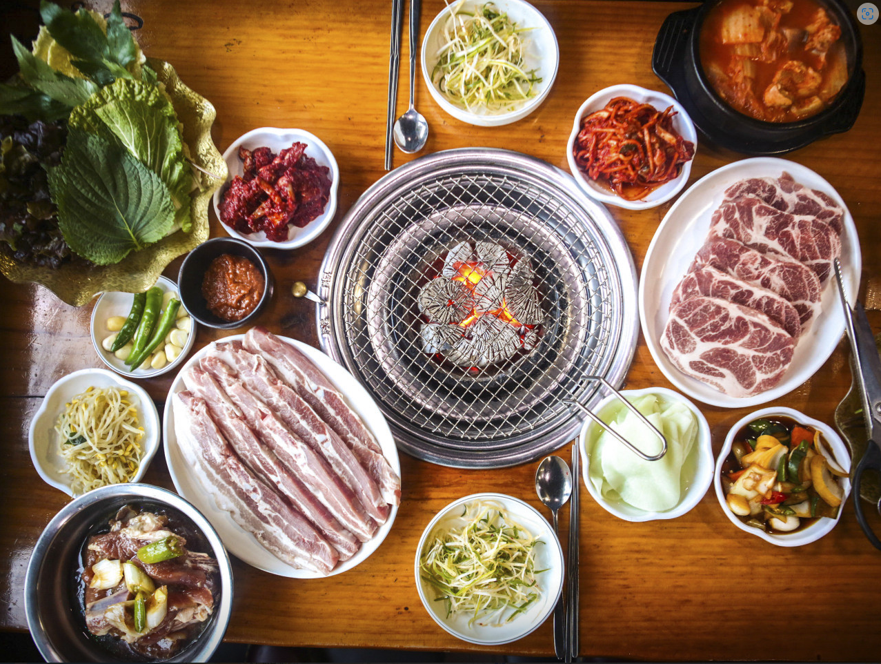 Daesung Galbi table with pork ribs, steamed egg, marinated crab and greens