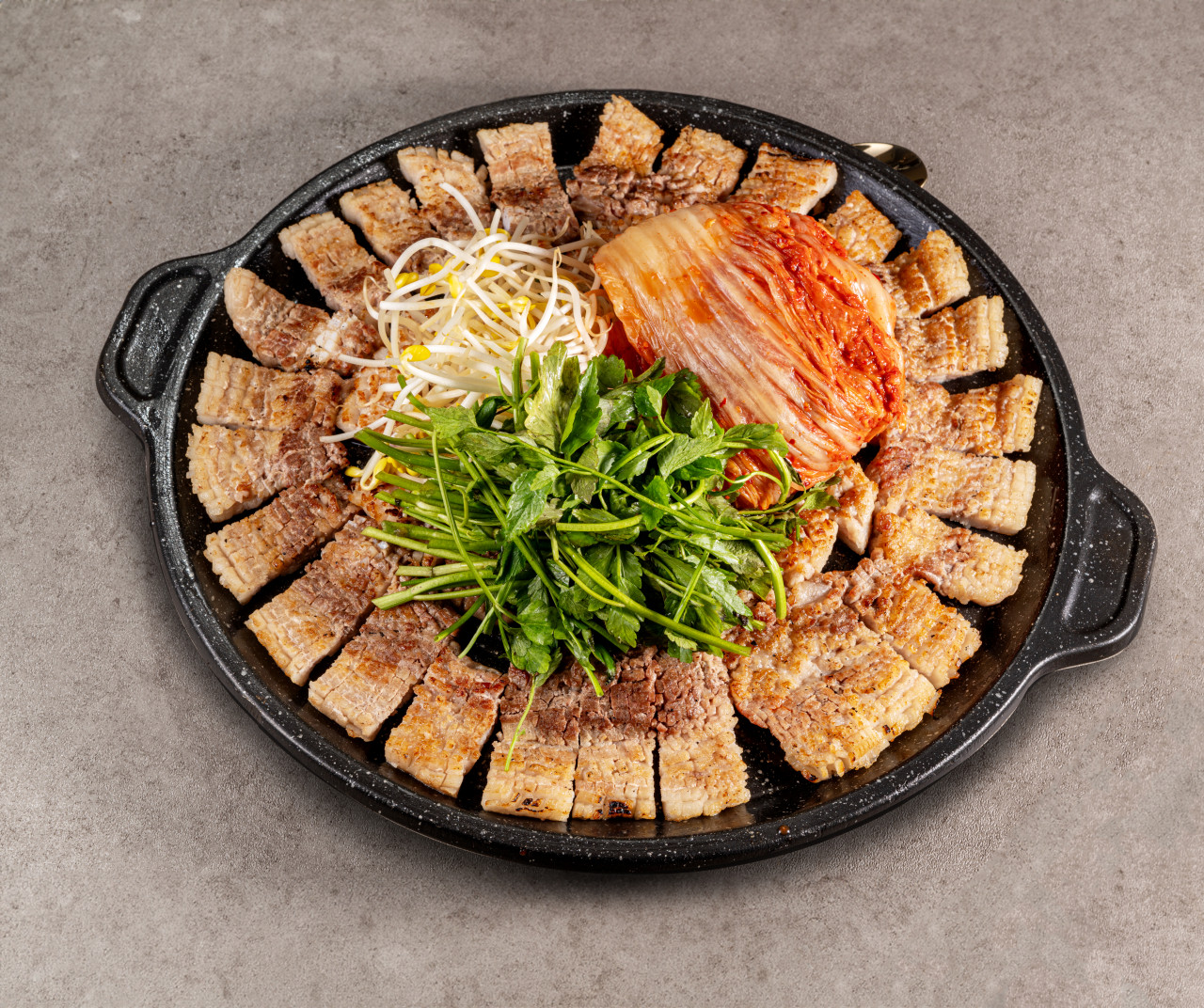 Kotsam Ttuggeong black pork belly on the grill