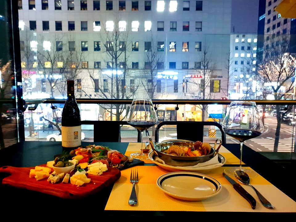 Paletto rooftop terrace with wine glasses at sunset