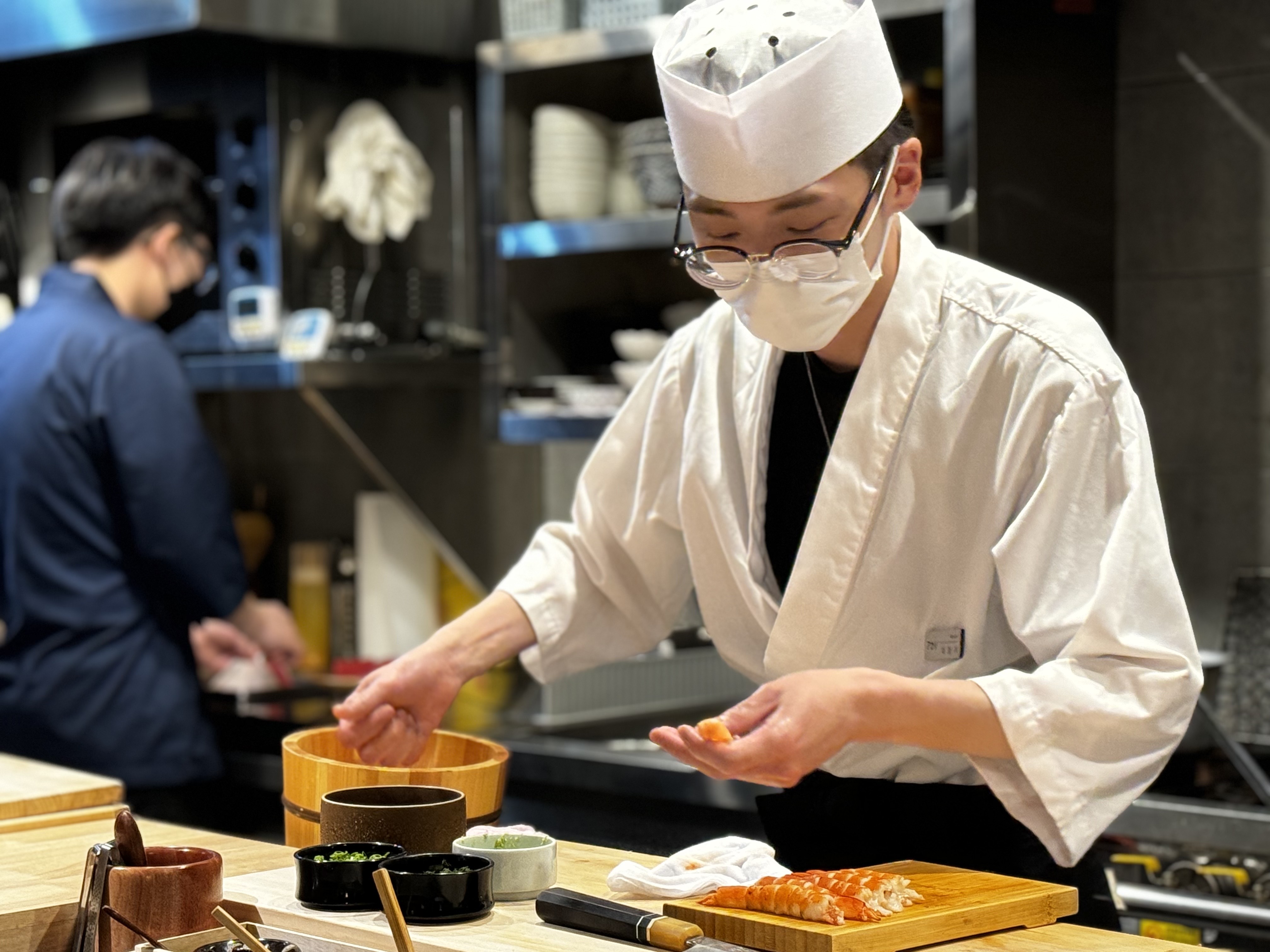Sushi Akari omakase counter with warm lighting near Gwangalli