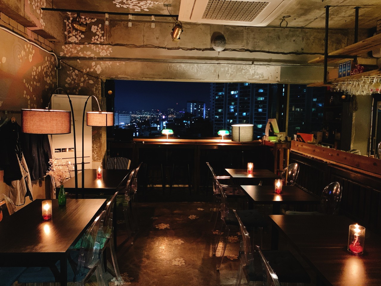 Tom's Kitchen window with sunset city view and Italian plates