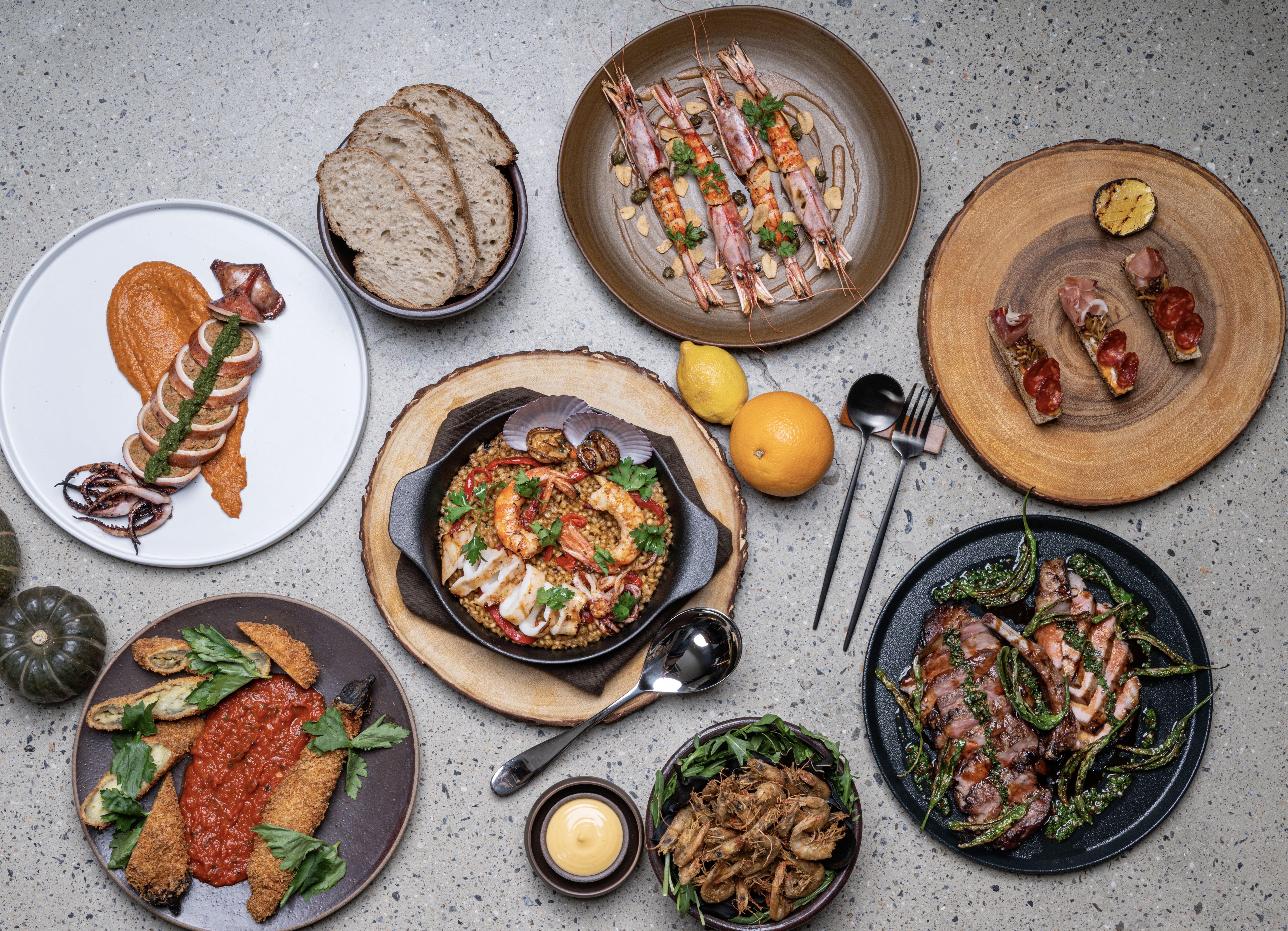 Wine poured at sunset over Seongsu skyline with tapas-style plates