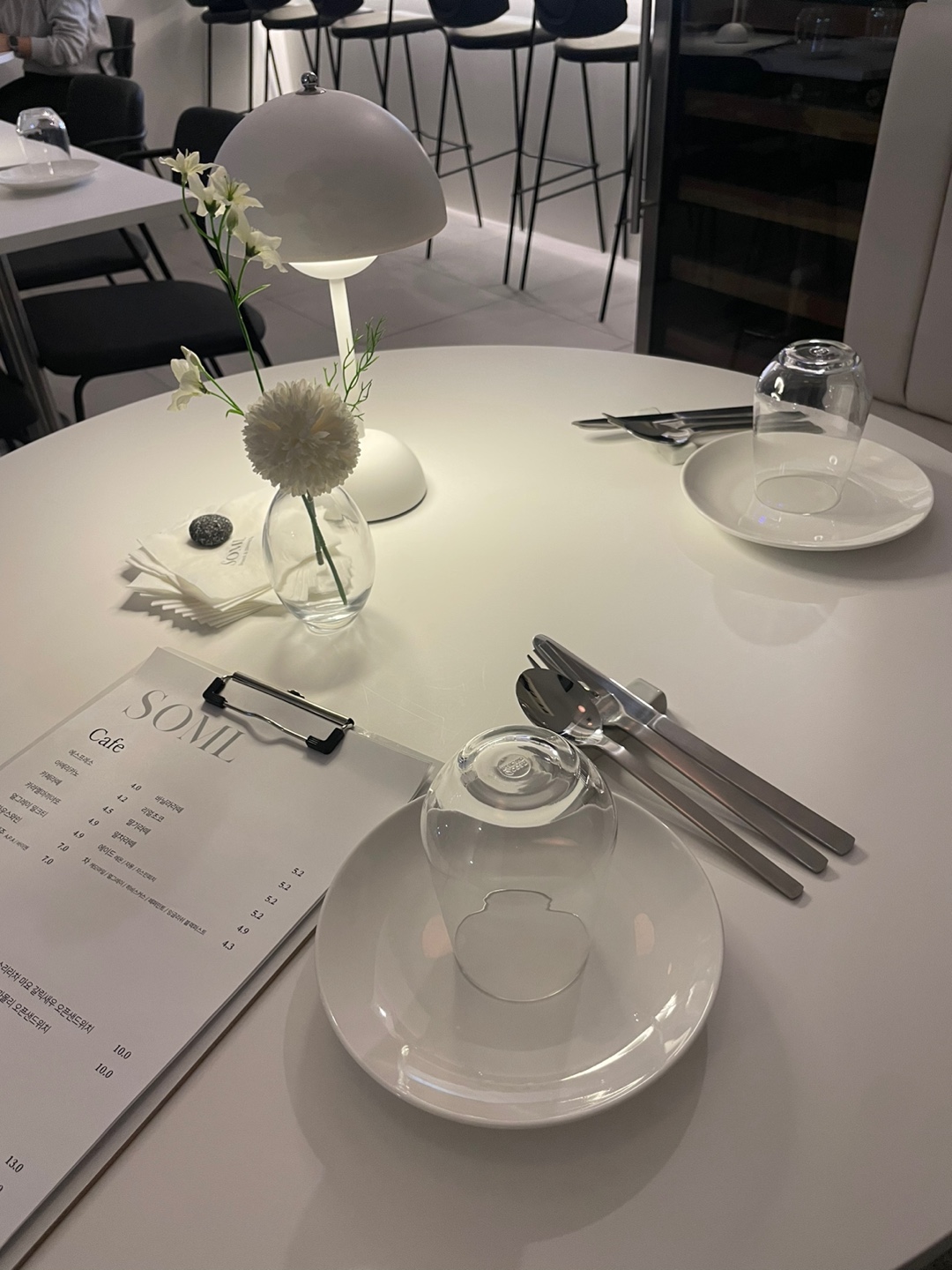 Sunlit wine dining bar interior at Soml with high ceilings and cozy evening lighting