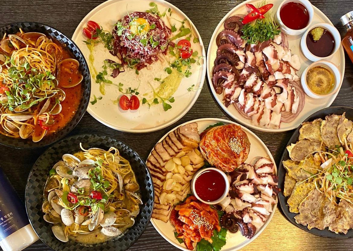 Korean pub spread with bossam kimchi and traditional liquor at Mirrorball Korean Bistro