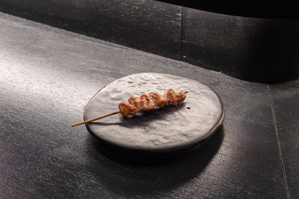 Yakitori skewers over charcoal at KUSHIKURO