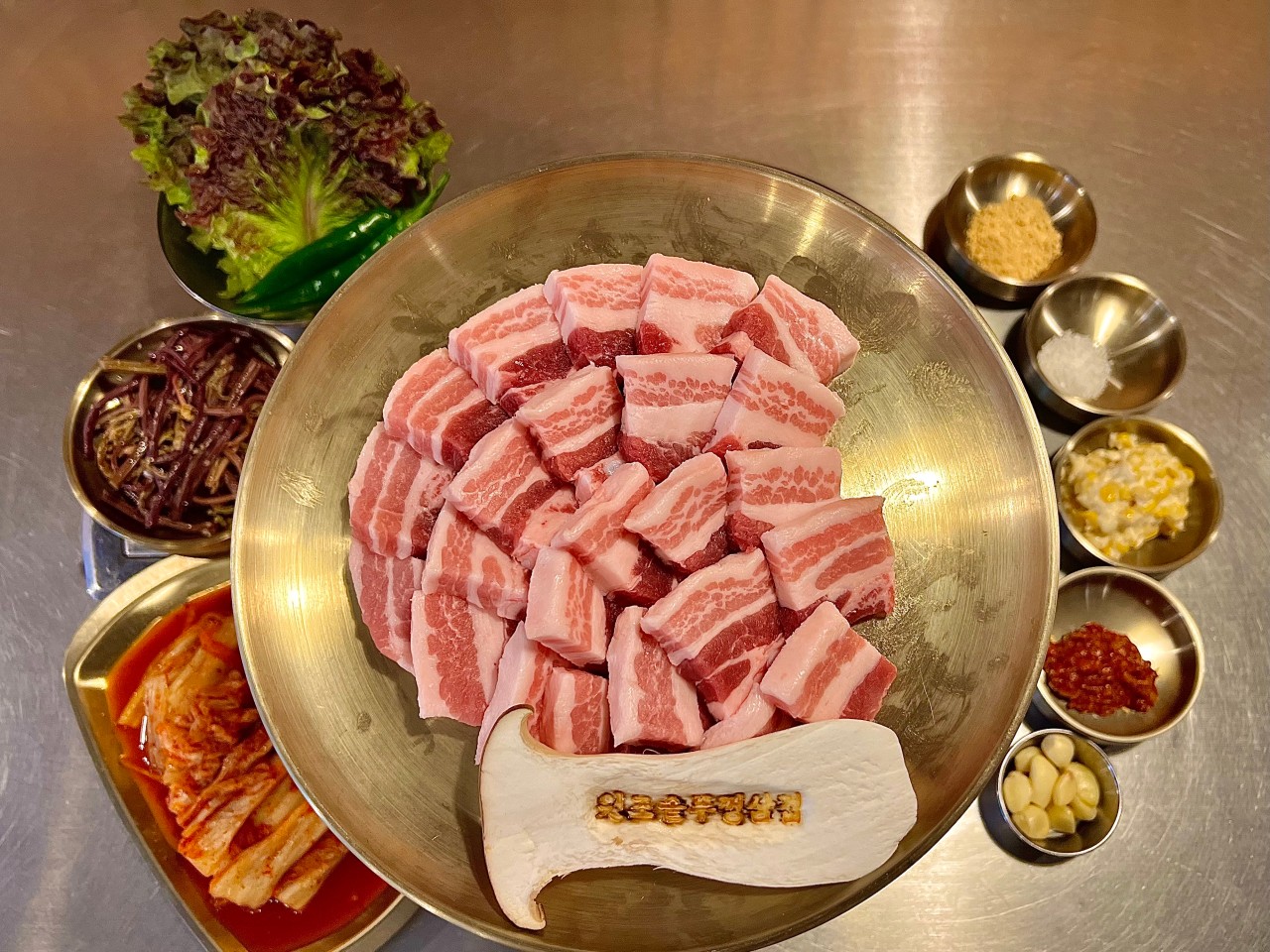 Cast-iron pot-lid grilled samgyeop and house kimchi at Chungjeongno