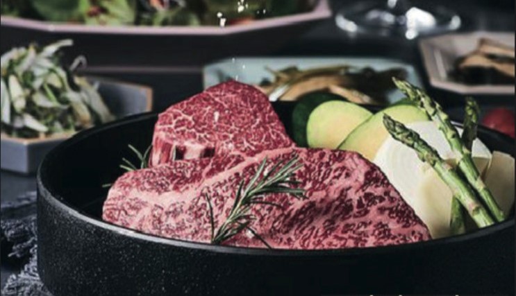 Puerco Yeouido corkage free grill with staff searing aged beef and Iberico