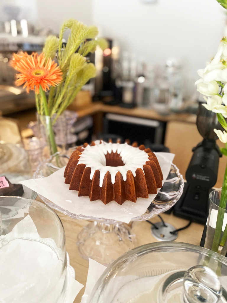 The Buttons sunlit cafe table with natural plates and green grape lime ade