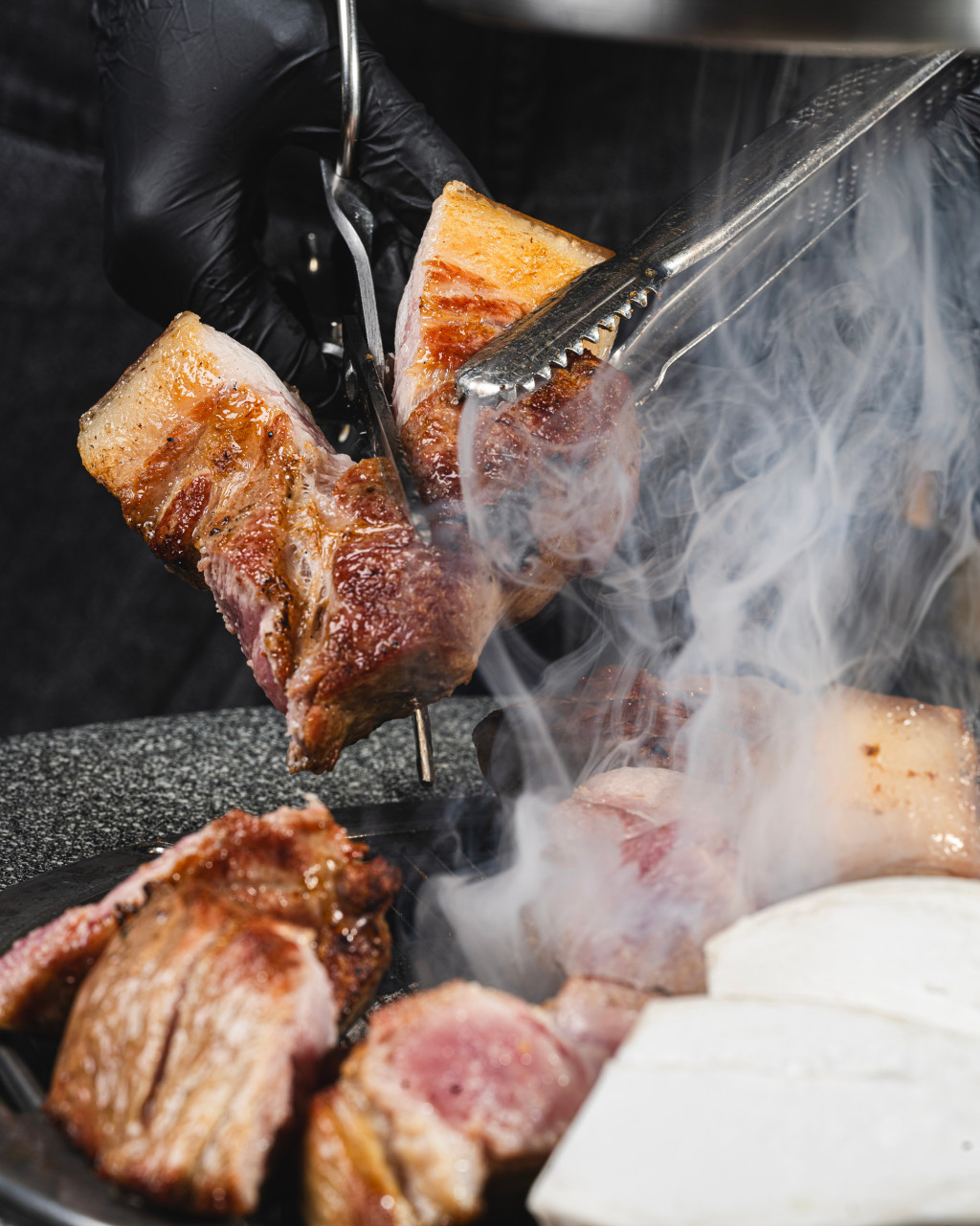 Donsunjang Jeju pork bone rib samgyeopsal sizzling on the grill