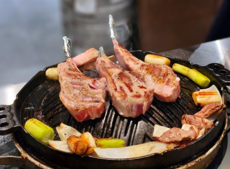 Staff-grilled lamb chops on personal hot plate at Ichiryu Mokdong