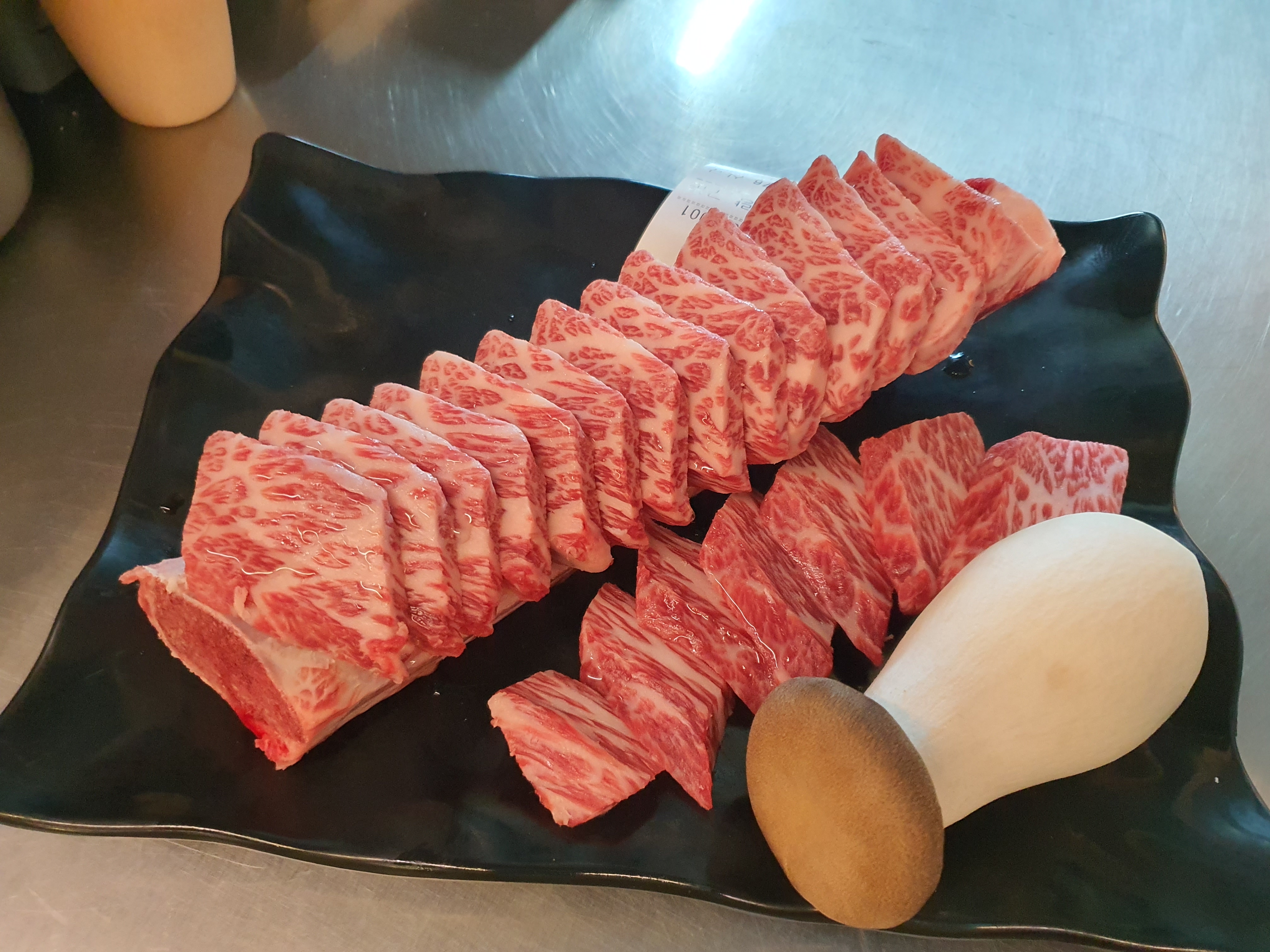 Unyang-style bulgogi grilling over wire rack with view of Gwangandaegyo