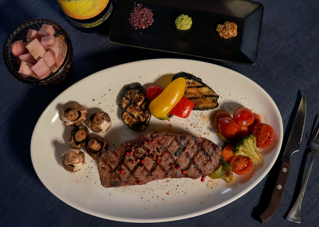 Hyehwarang Hanok wine bar with warm lighting and wood beams