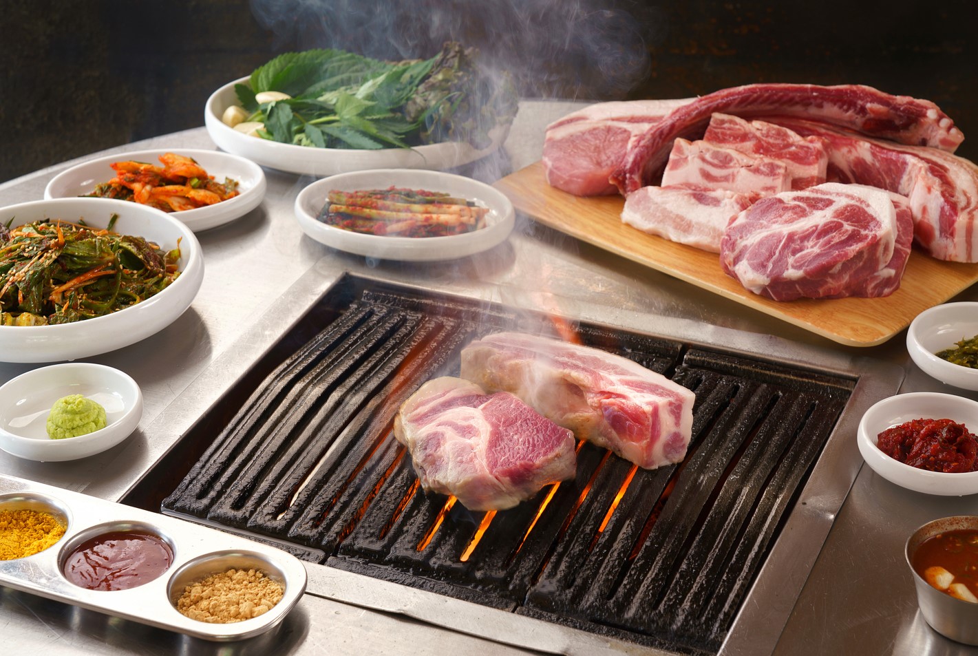 Dosan Butchers first-floor charcoal grill with side dishes