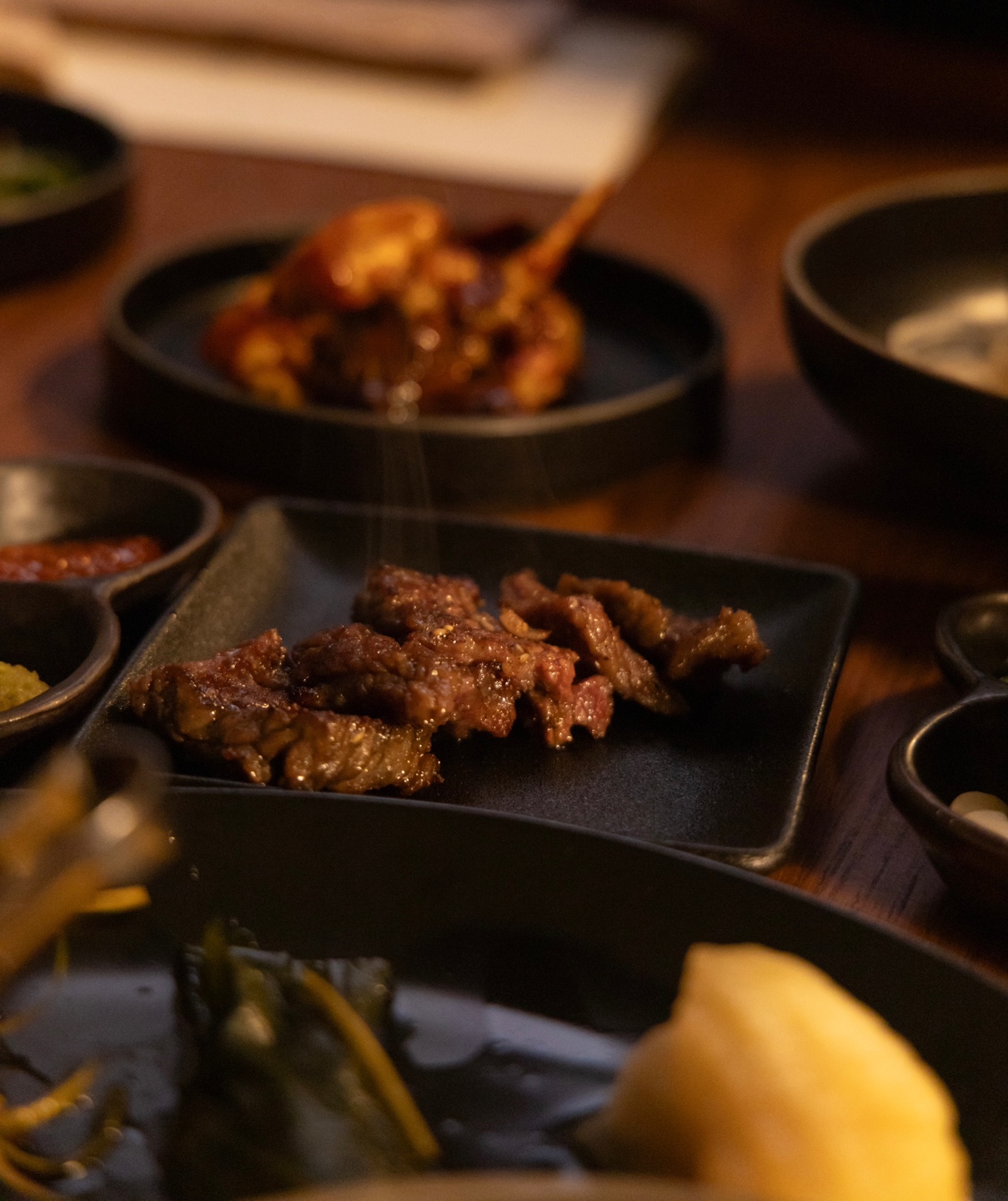 Kangjin charcoal pork ribs grilled by staff in a warm atmosphere