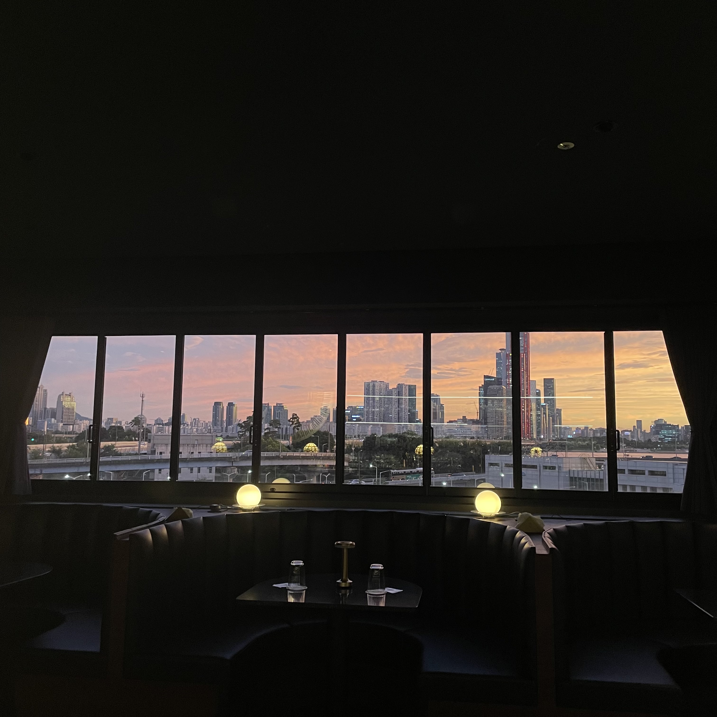 Night view bar with backlit whiskey shelves at Maltbar Rubato