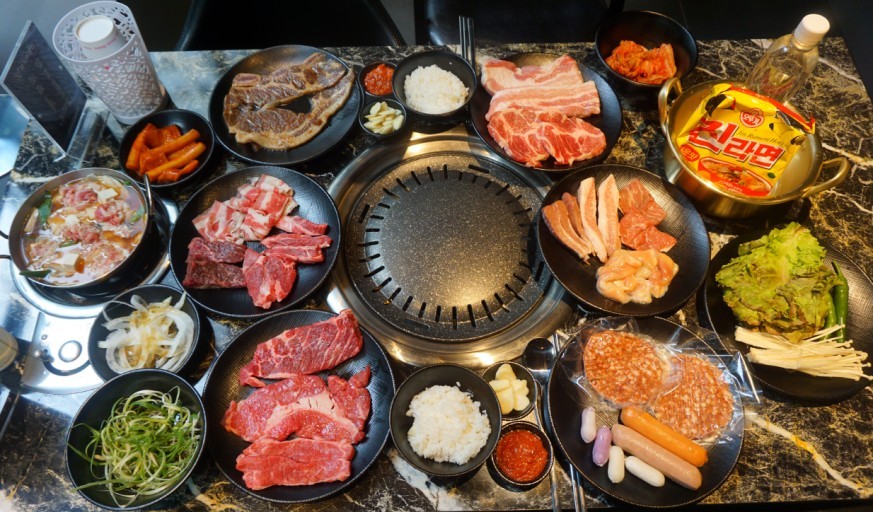 24/7 unlimited meat grill platters on a lively table