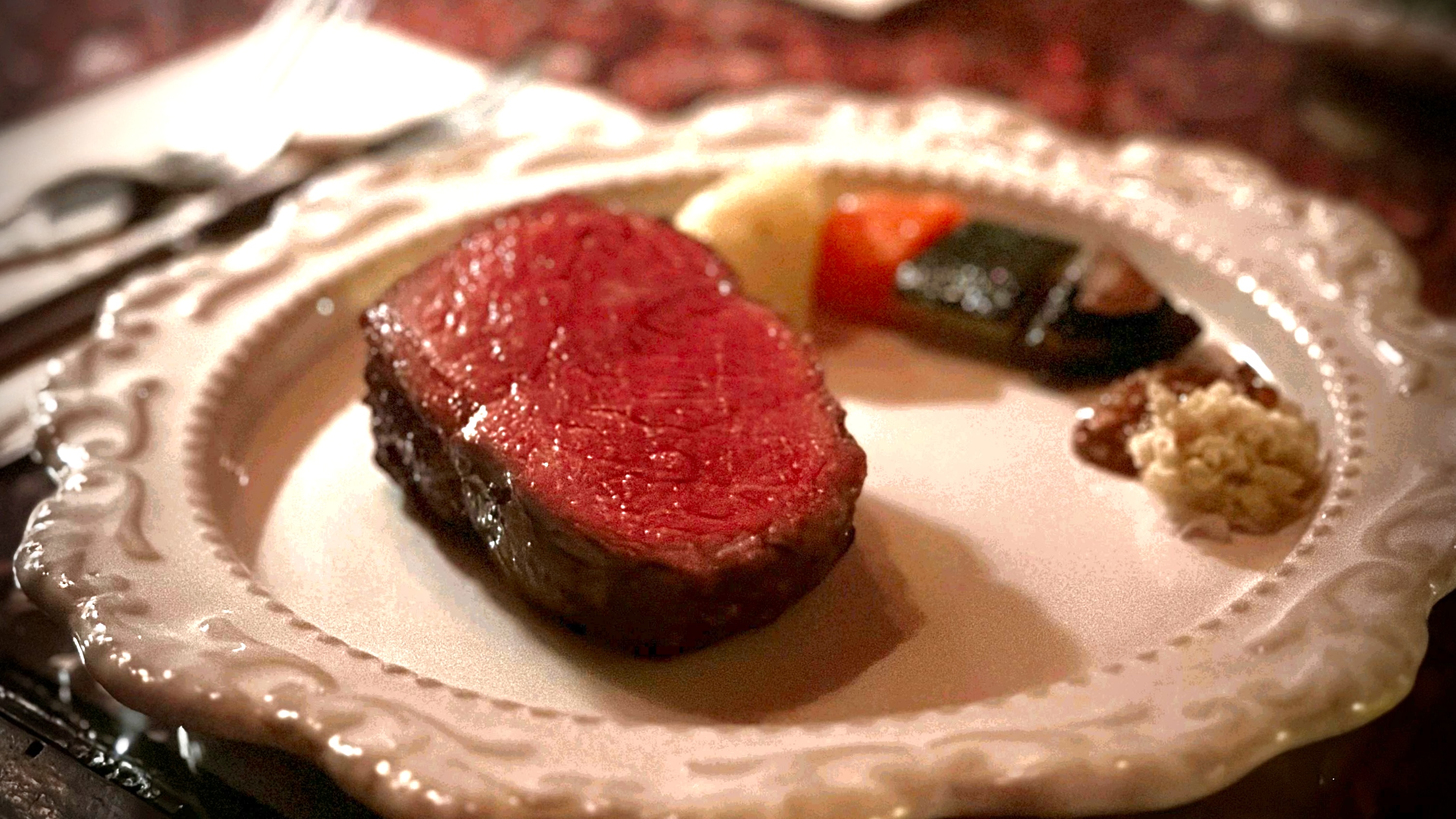 T:M Wine&Steak direct-fire steak with wine bottles in background