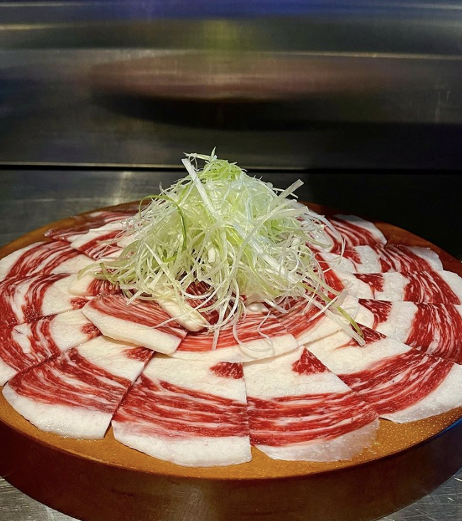 Baekyang Grill Korean beef cuts with white kimchi and deodeok