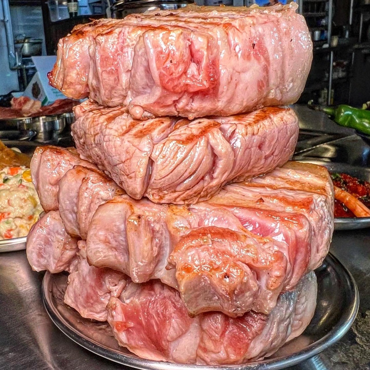 Moong Tung Dongam thick-cut pork searing on a custom griddle