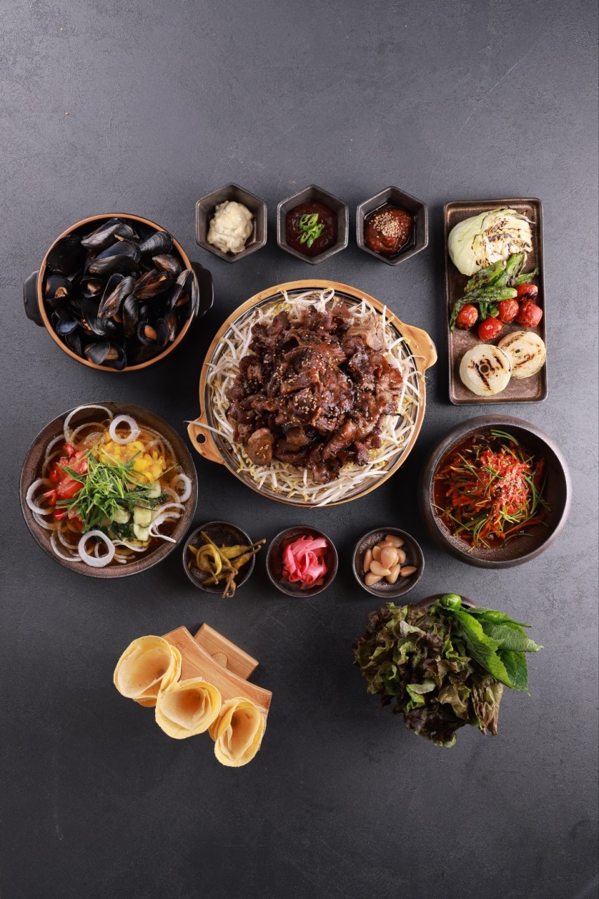 Haepo oak-wood grill with glowing embers and seared pork intestines