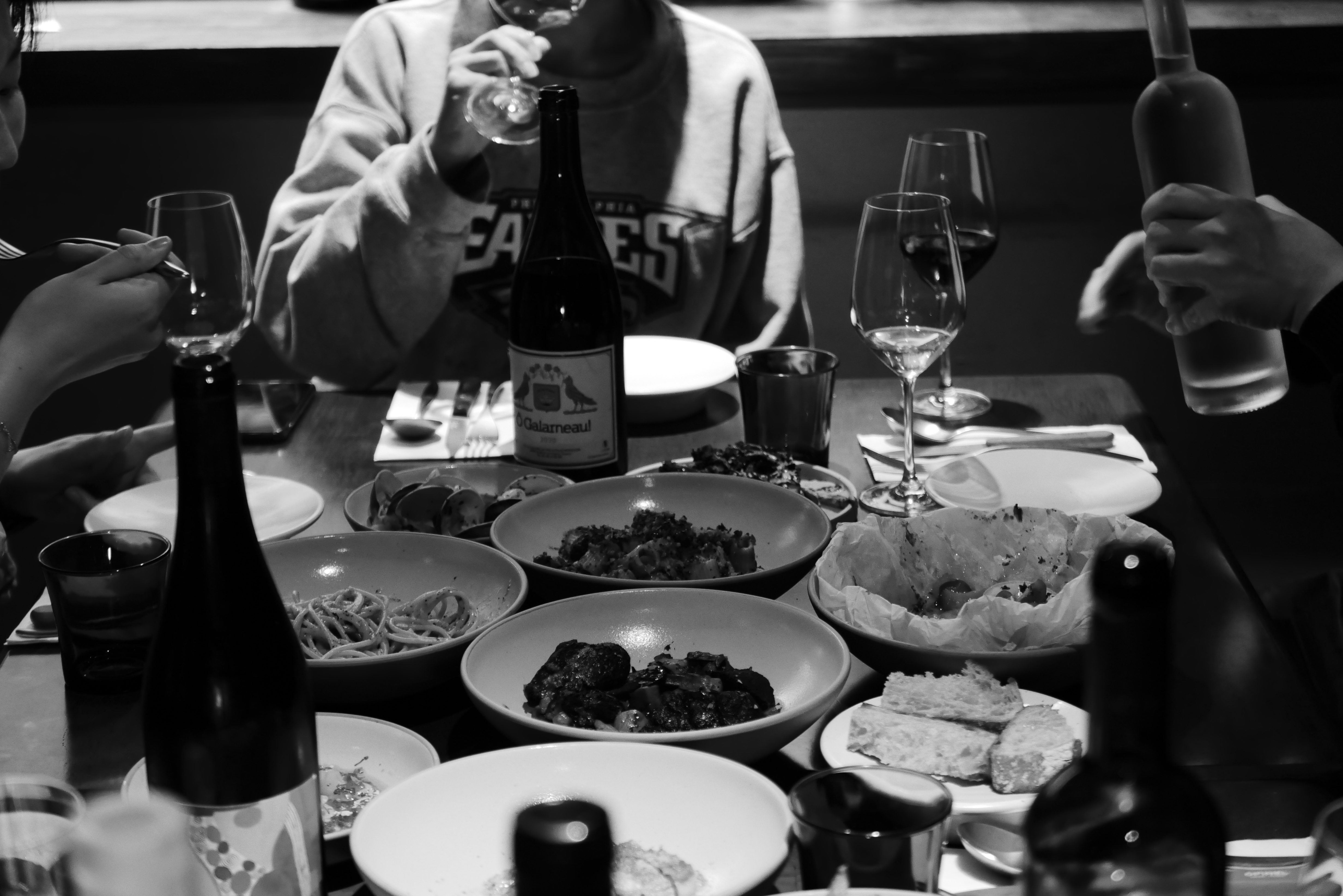 tas. candlelit table with natural wine and small plates