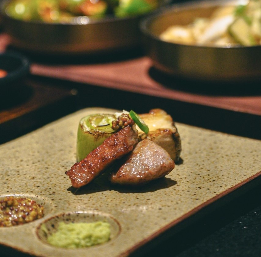 Puerco Yeouido aged Hanwoo and Iberico being grilled