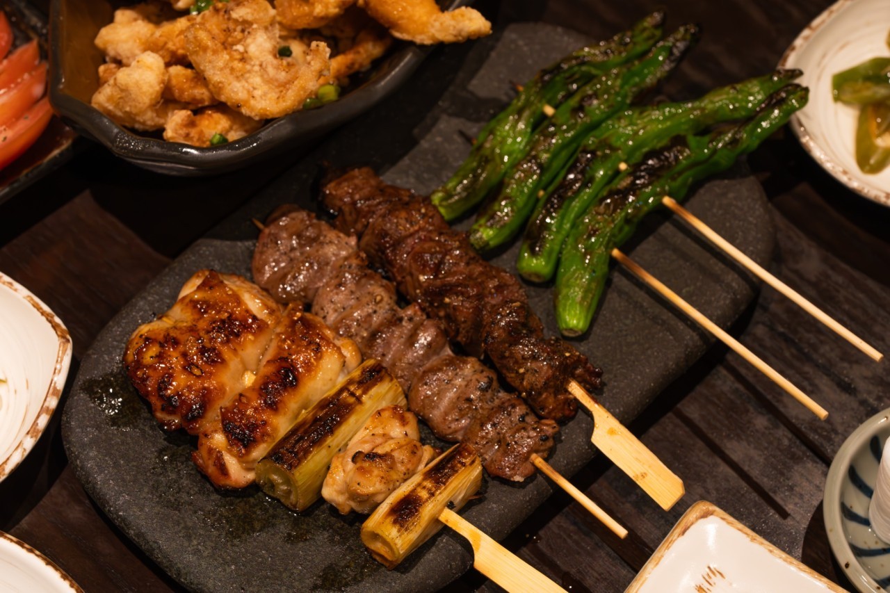 Yakitori Satori skewers grilling over premium charcoal