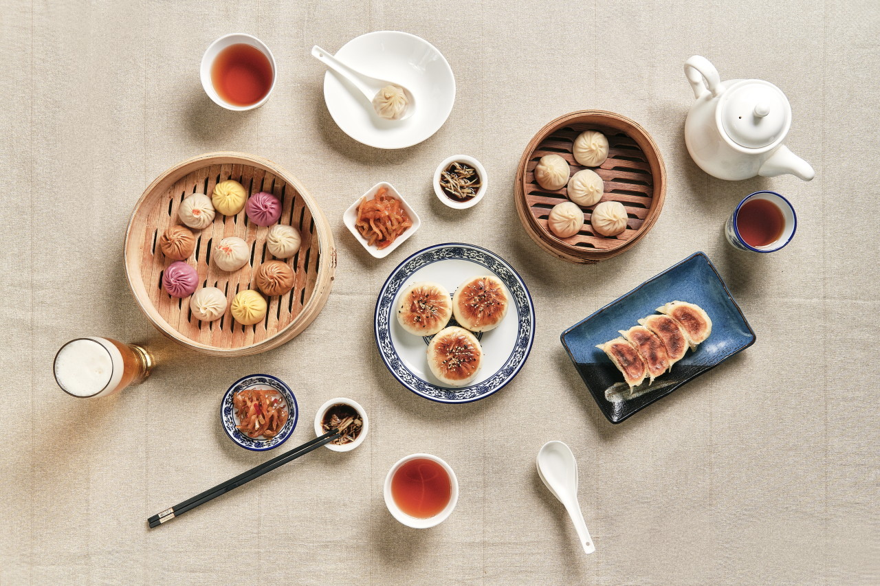 Crystal Jade Daegu steamer basket of soup dumplings and Shanghainese sides