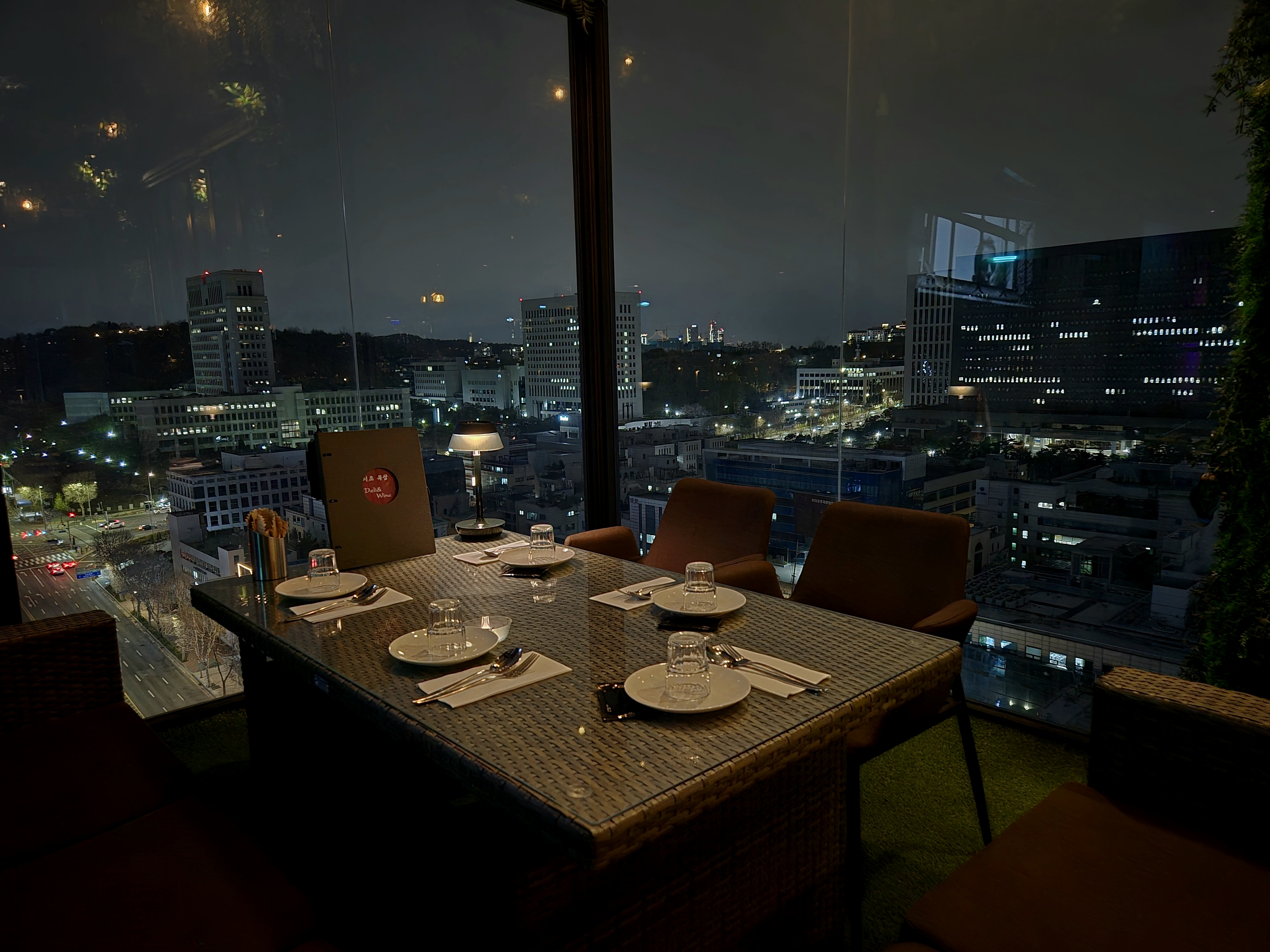 Seocho Oaksang rooftop view and wine glasses at sunset