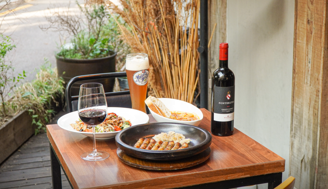 Wine Ryul Yeonhui grilled lamb chops and wine glasses in a cozy cabin-like room