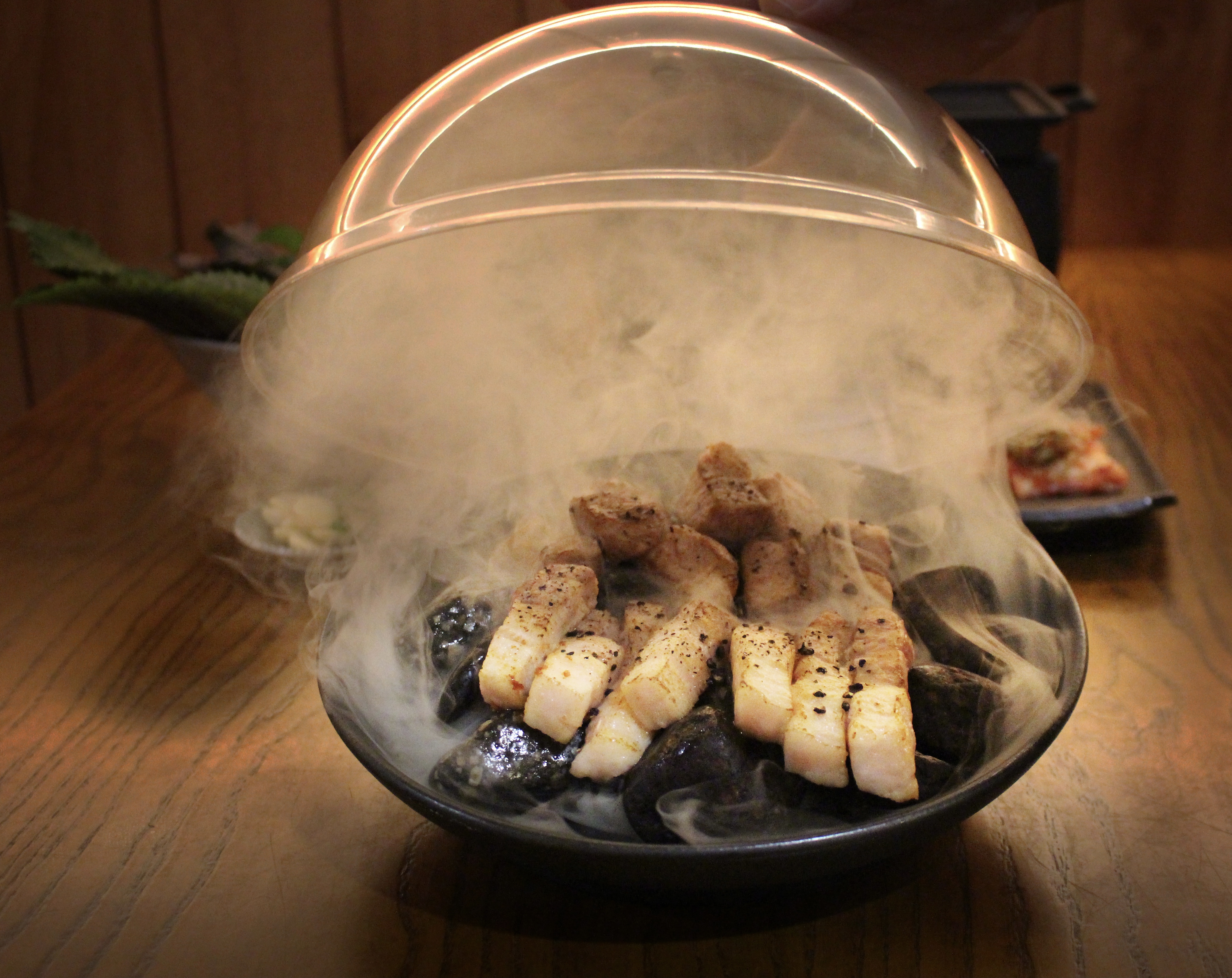 Woody agarwood-rested pork course plating