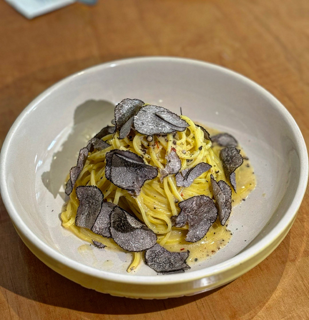 Nice Time pasta and wine on a wooden table