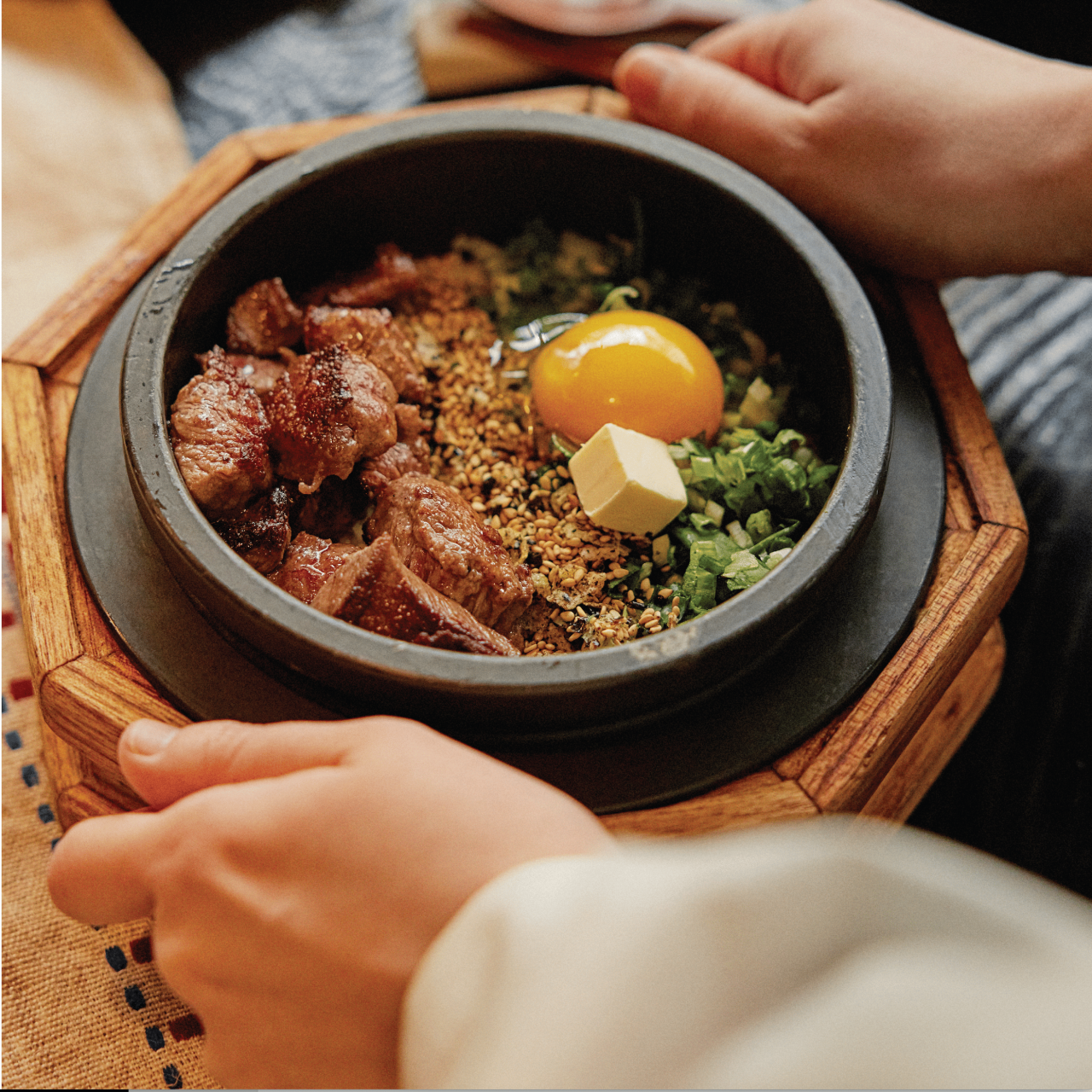 Solsot stone pot rice opened tableside with seasonal toppings