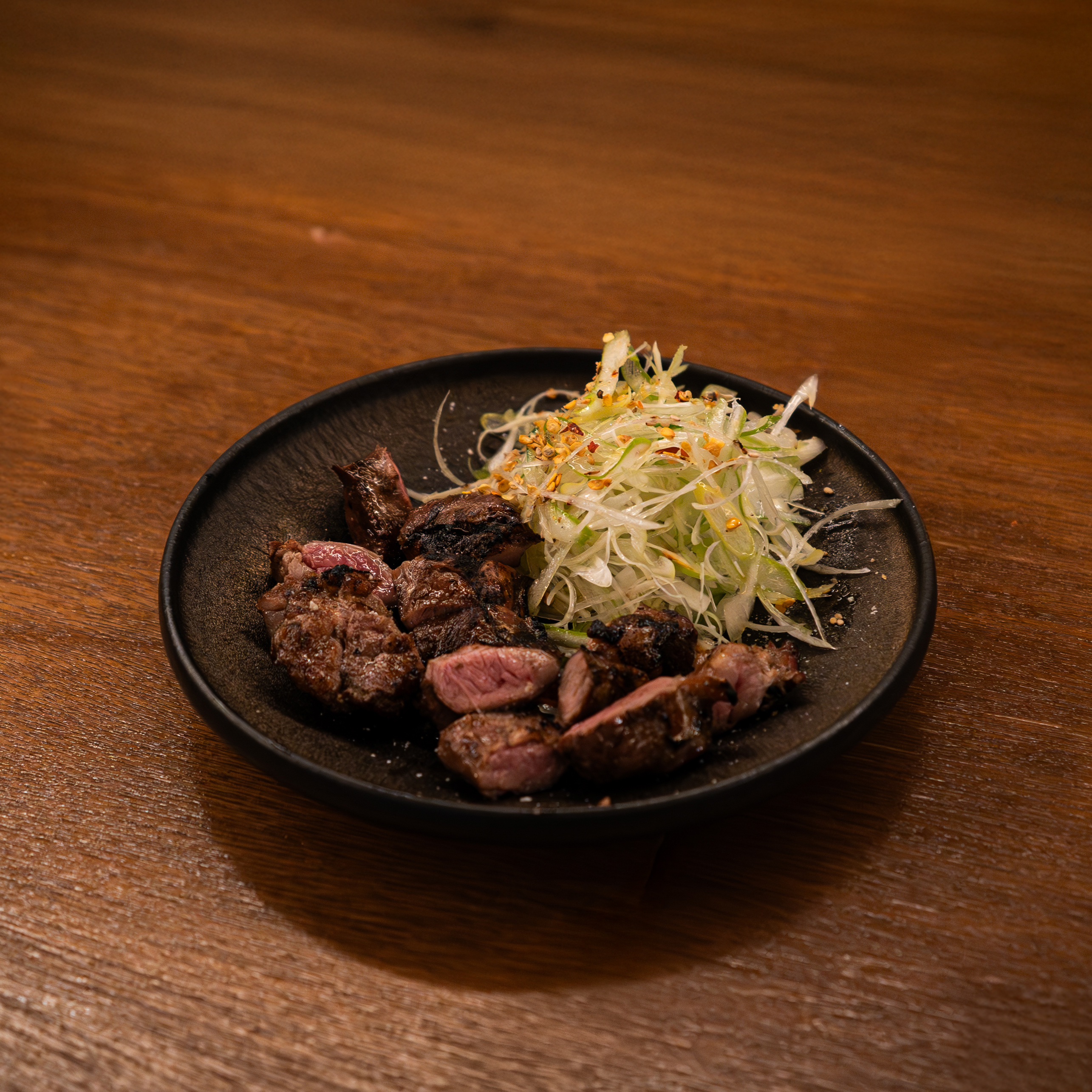 Sanjaewoo wood-fired kitchen with seafood and black pork on the grill