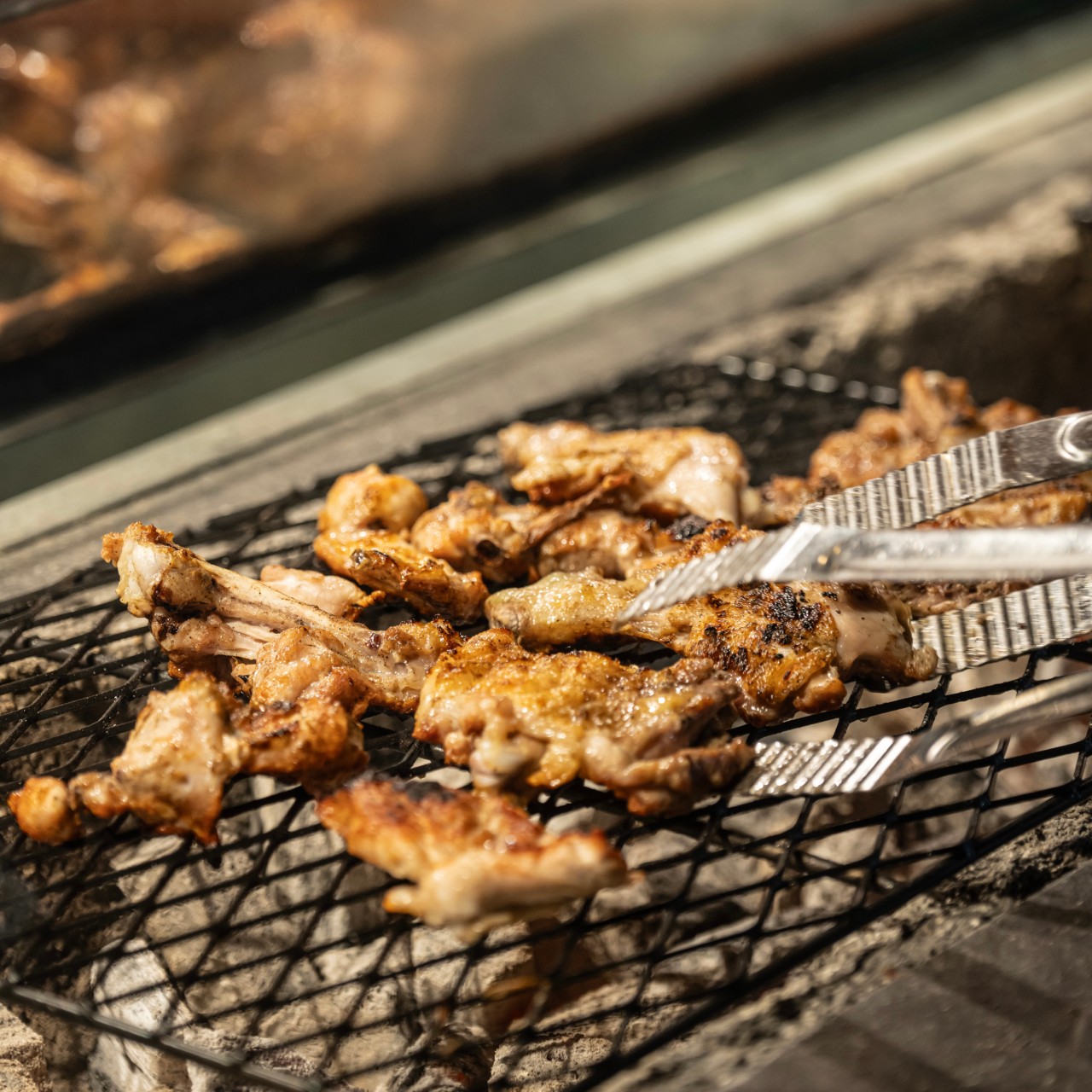 Charcoal chicken barbecue under moonlit plaza vibes at Euljiro