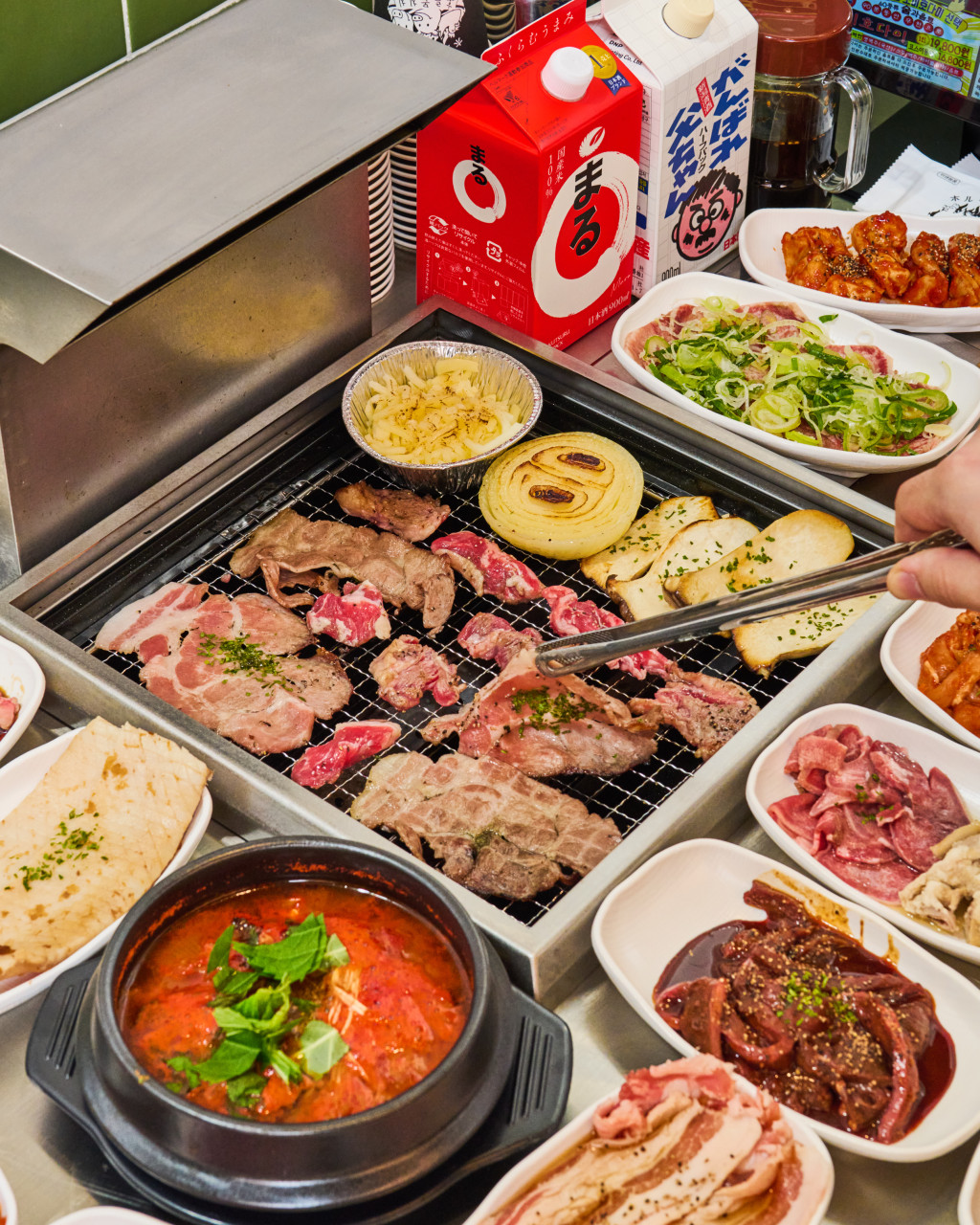 Horumon Chichi all-you-can-eat tongue and assorted meats on the grill