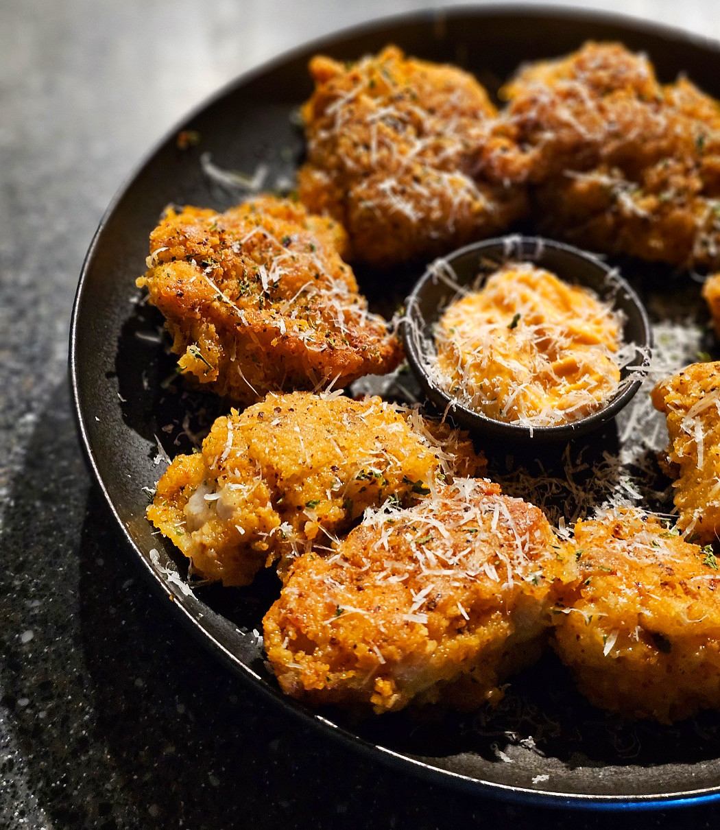 Cozy pub plating chef’s signature small plates with highballs