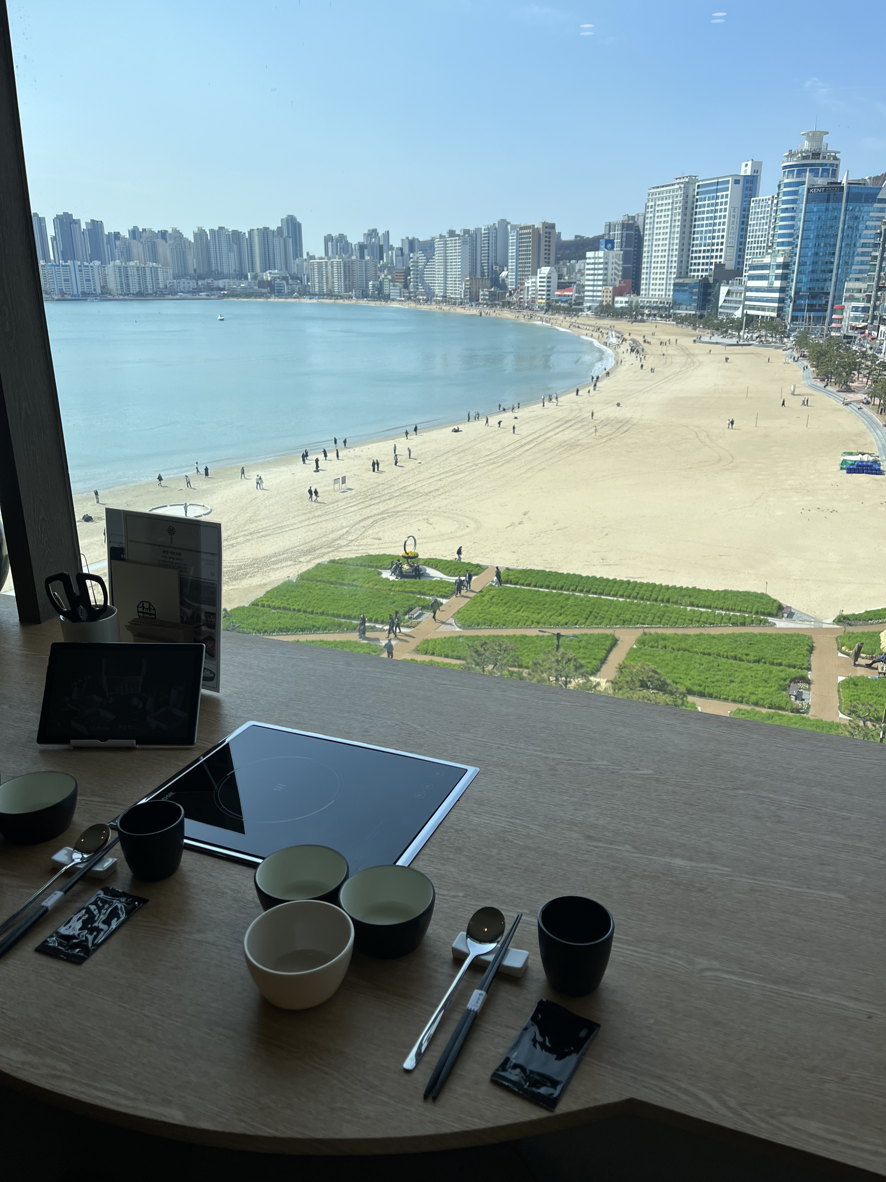 Ocean-view table with peanut-infused galbi pot and freshly cooked rice at MokMok