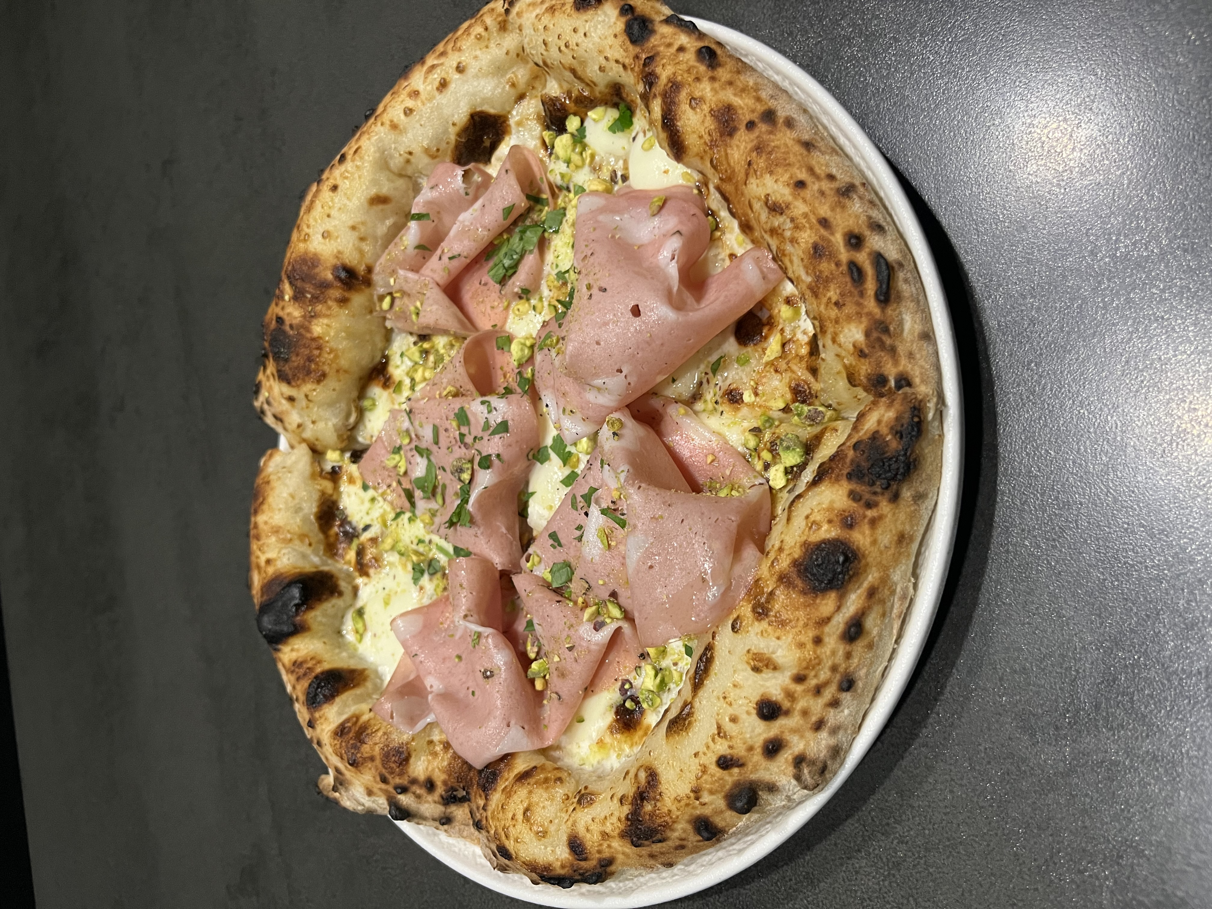 Osteria Radici classic pasta and Neapolitan pizza in moody black-toned interior