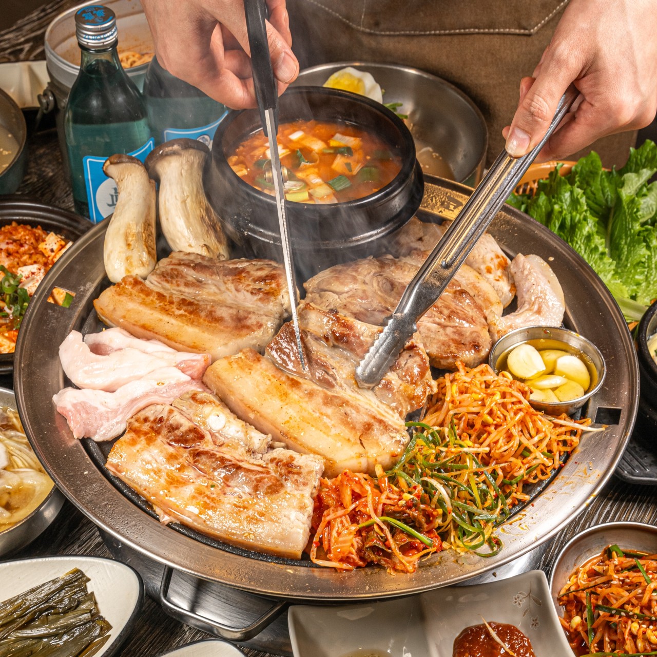 Ttangko Charcoal Grilled Seongsu busy dining room with pork neck on charcoal