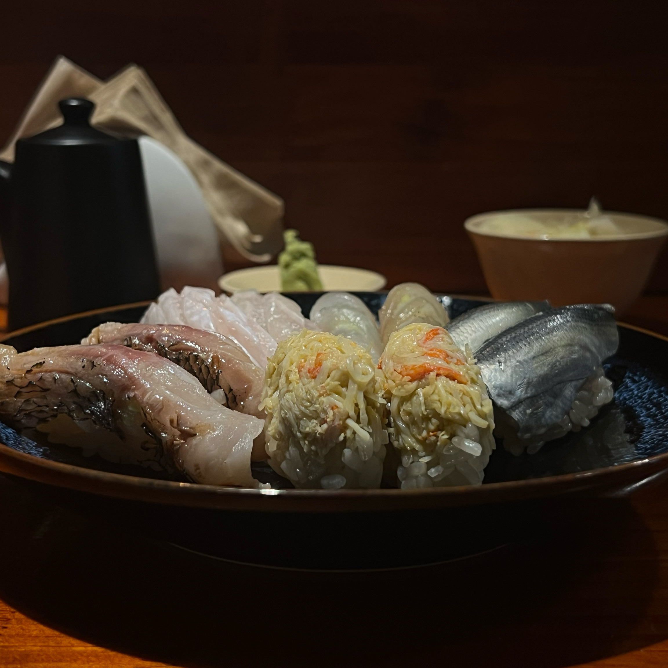 Sushi sakaba bar seating with premium nigiri and sake