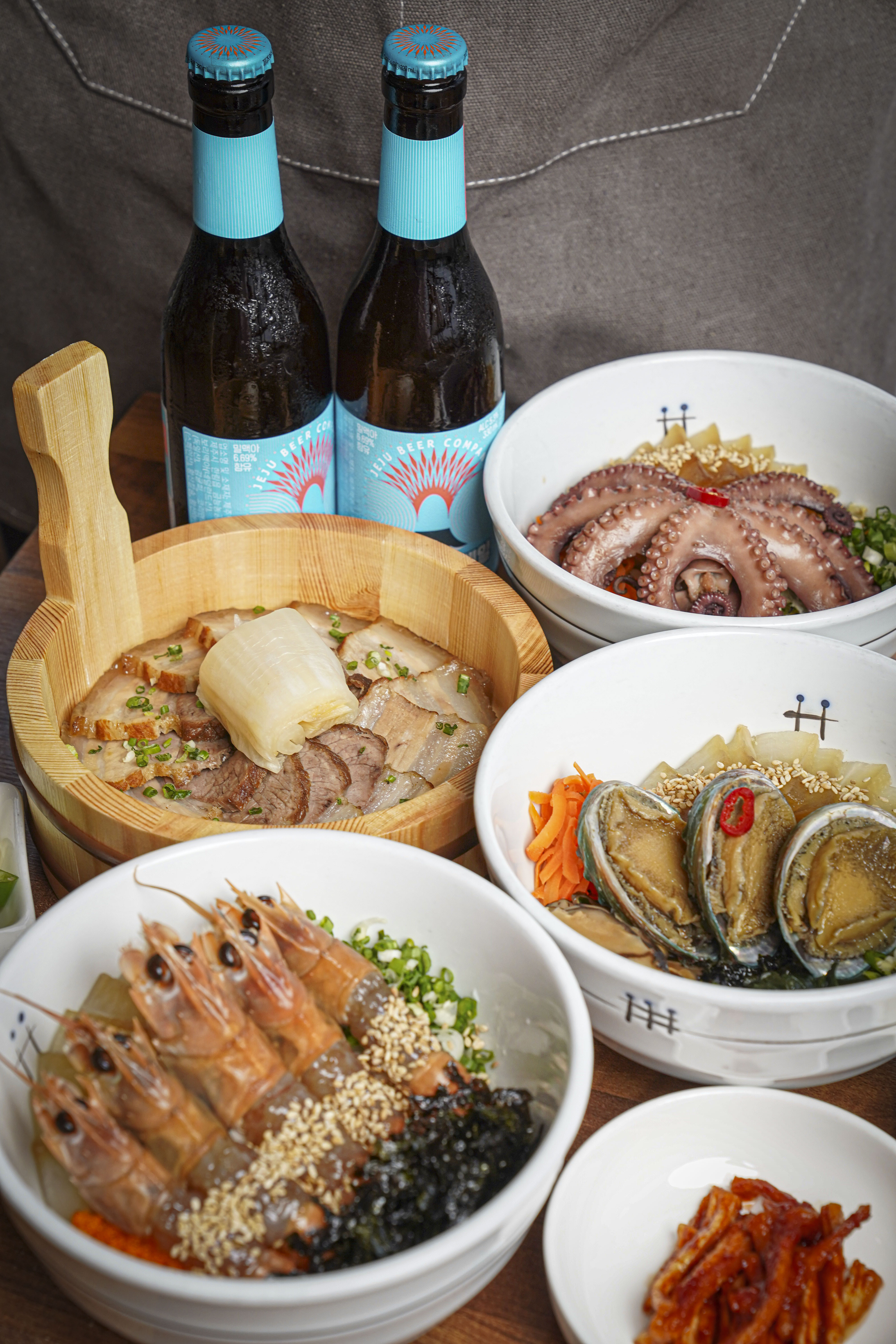 Hi Hyeopjae set table with simmered broth dishes near the beach