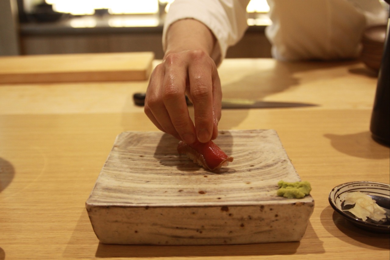 Sushi miztei omakase counter with chef plating nigiri