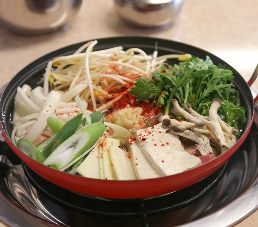 Gangsangdosik pork stew bubbling in a pot