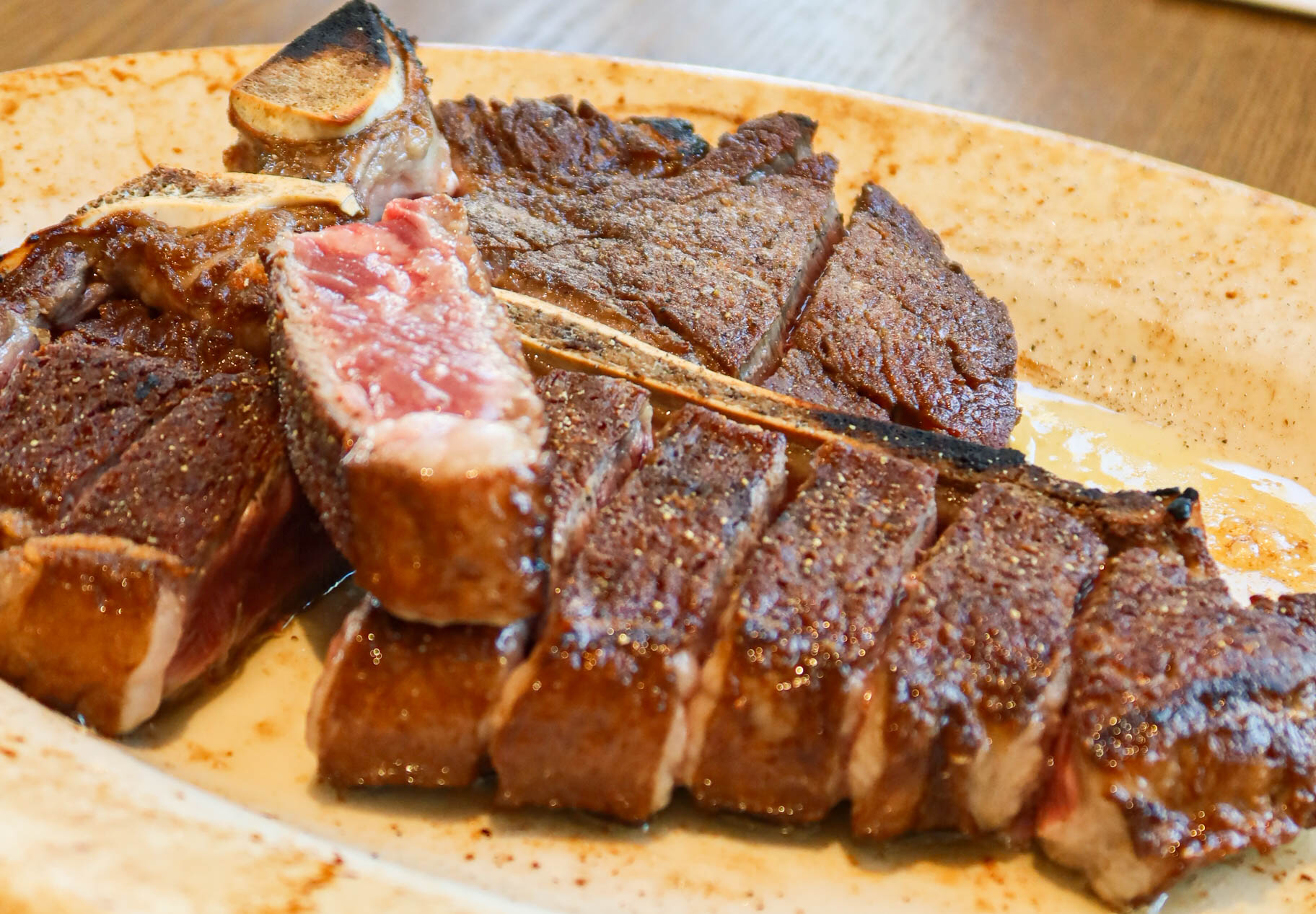 Viqueld Italian American Steakhouse skyline-view dining room with steak and cream pasta