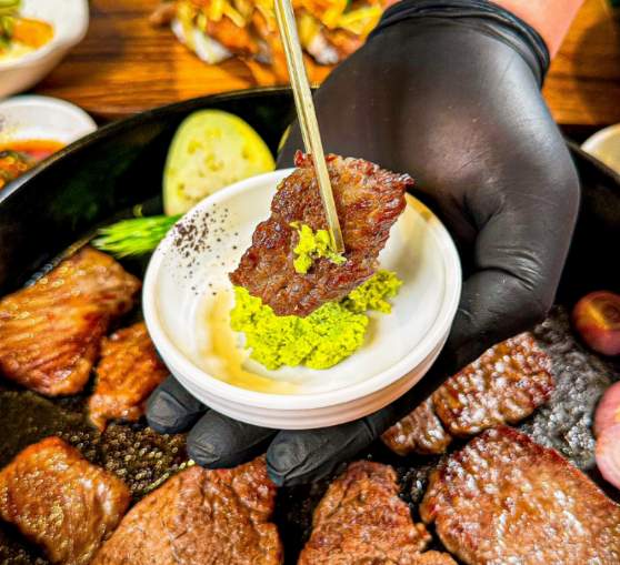 Dongnae Byeoljang grilling beef in a camping-inspired setting