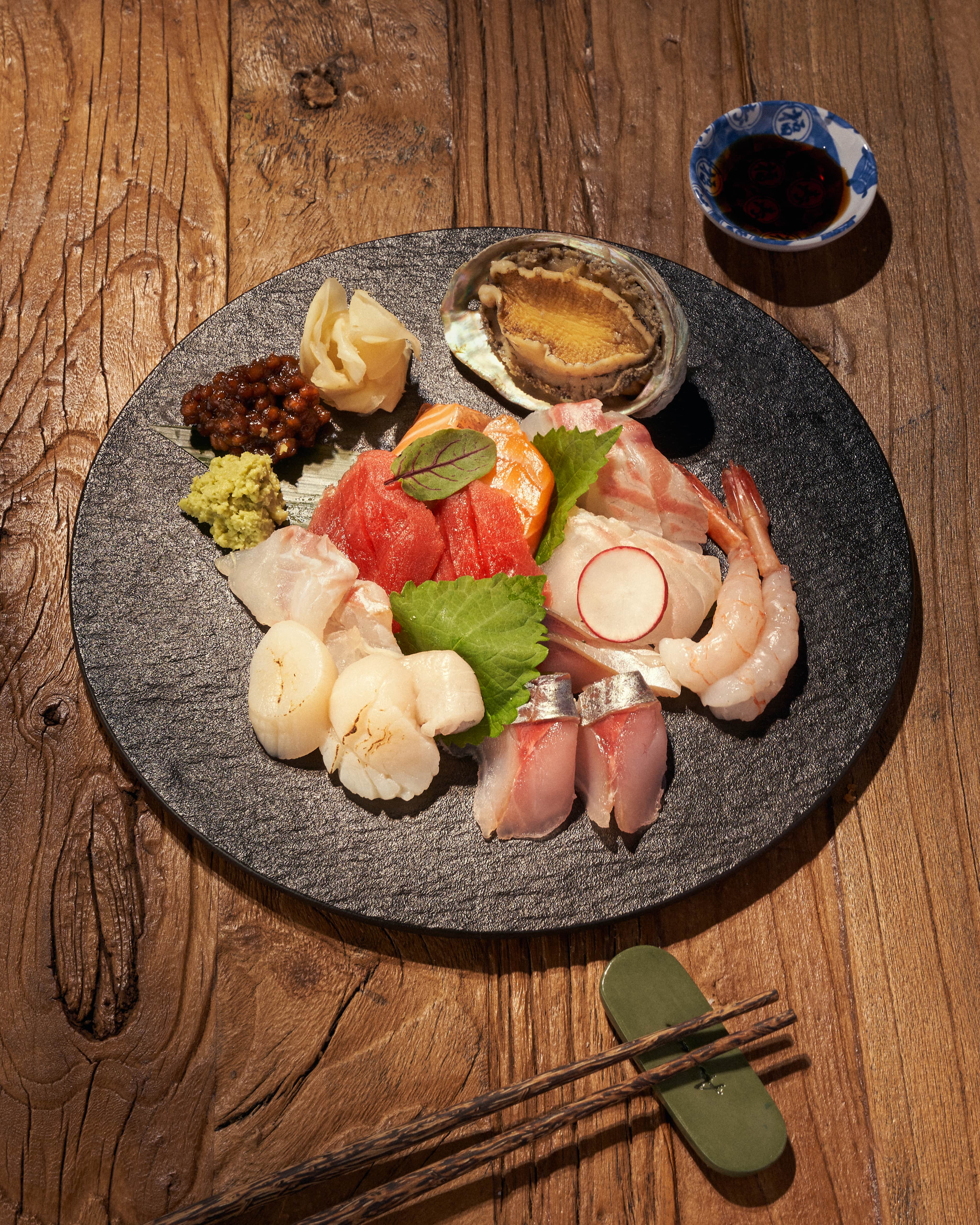 Anzzang kushikatsu and sashimi in sleek izakaya setting